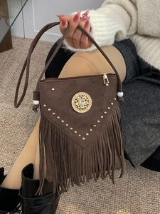 Bohemian brown tassel crossbody bag with golden rivets and faux suede finish