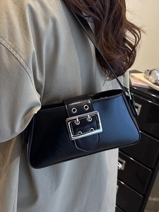 Minimalist black faux leather shoulder bag with silver square buckle and metal eyelets