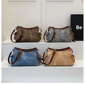 Close-up of stylish shoulder bags in multiple colors with functional side pockets