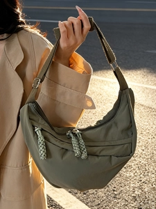 Minimalist olive green nylon crescent crossbody bag with adjustable wide strap and pleats
