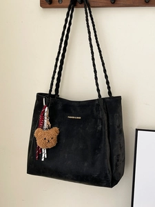 Classic black tote bag with braided straps and brown plush bear charm for daily commute