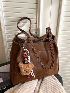 Brown large capacity tote bag with woven handles and cute plush bear accessory