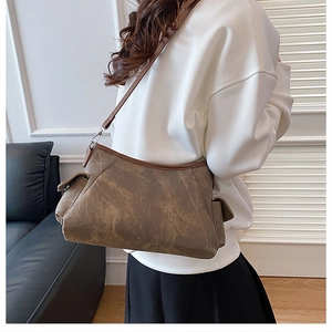 Detailed side view of vintage brown canvas crossbody bag with multiple storage side pockets