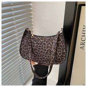 Detailed view of the vintage leopard print underarm bag with gold metal buckles and zipper