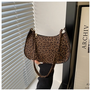 Detail of the vintage leopard print baguette bag with golden metal zipper and wide strap