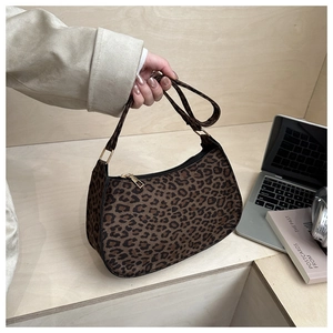 Detail of hobo leopard print underarm bag with gold metal buckle and zipper closure