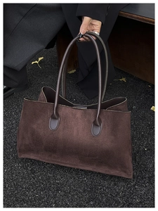 Deep brown suede tote bag featuring a spacious interior and leather-reinforced round handles