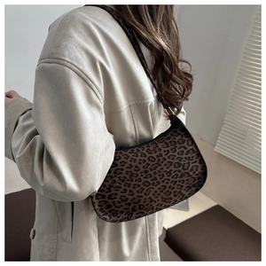 Detailed back view of leopard print baguette bag on shoulder with vintage brown pattern