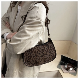Detail of hobo baguette bag with vintage leopard pattern and gold metal hardware