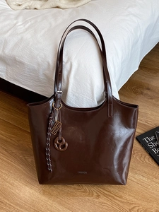 Large dark brown leather tote bag for women with fashion lettering and decorative keychain