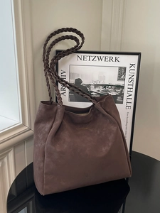 Brown suede tote bag with woven shoulder straps and gold logo for daily office commute