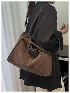 Detail view of large leopard print suede tote bag showing texture and spacious capacity
