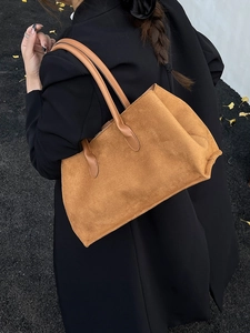 Caramel corduroy tote bag for women with leather straps shown on a model in autumn