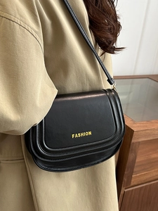 Fashionable black leather flap crossbody bag for women with gold letter detail