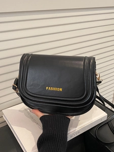 Chic black PU leather saddle bag with gold logo lettering and adjustable shoulder strap