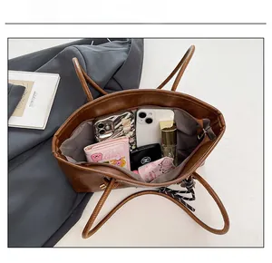 Top view of large brown tote bag showing spacious interior with zipper pocket and lining