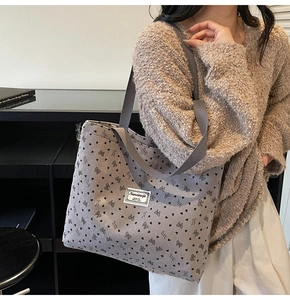Detail of grey corduroy tote bag featuring heart pattern and Nanxiaojie brand label