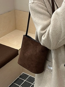 Minimalist dark brown suede bucket bag for women with leather strap and retro matte finish