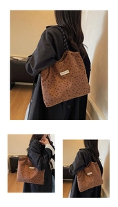 Detail of brown corduroy tote with bow prints and woven rope strap in a cozy setting