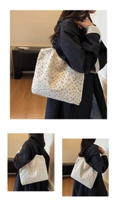Detail of corduroy tote bag with heart patterns and black rope shoulder strap