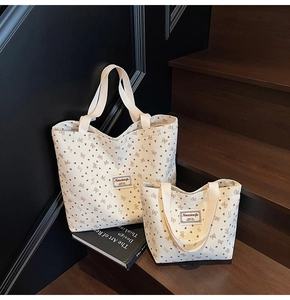 Two-piece corduroy tote bag set with heart bow print on vintage wooden steps