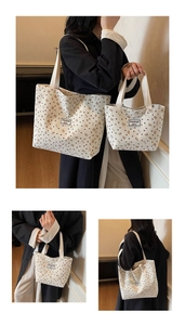 Close-up of off-white corduroy tote bag featuring brown bow and heart patterns