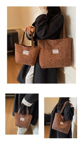 Close-up of brown corduroy tote bag with black heart pattern and bow print detail