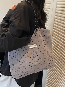 Gray corduroy tote bag with black heart and bow prints and woven rope strap for women