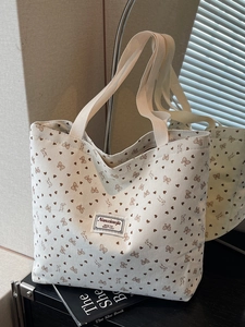 Beige corduroy tote bag with heart patterns and dual shoulder straps for daily commute