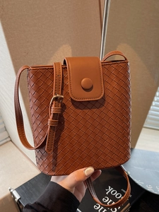 Chic brown woven bucket bag for women with cross-body strap and polished metal buckle