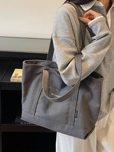 Minimalist dark grey canvas tote bag with BE YOURS print and versatile shoulder strap