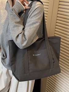 Minimalist dark grey canvas tote bag with Be Yourself print and wide shoulder straps