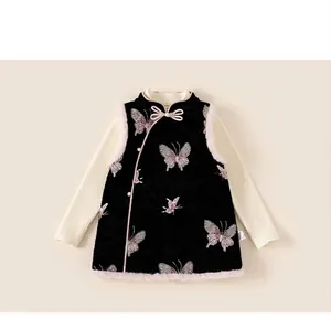 Detail of girls traditional velvet vest with butterfly embroidery and faux fur trim