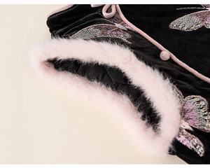 Close-up of black velvet dress with pink fur trim and traditional Chinese embroidery