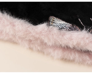 Detail of pink faux fur trim and silver embroidery on black Chinese New Year girl's outfit