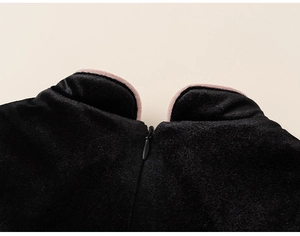 Close-up of girls velvet dress with mandarin collar and hidden back zipper detail