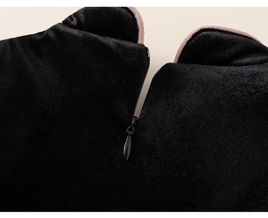 Detail of black velvet girls' dress featuring a pink trim neckline and back invisible zipper