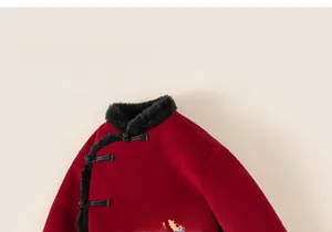 Detail of Chinese New Year outfit with traditional knots, fur collar and dragon embroidery