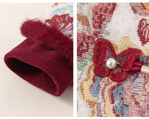 Detail of red brocade jacket with butterfly knot buckle and white pearl accent