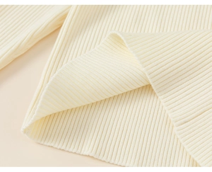 Detailed macro view of cream knitted ribbed fabric texture and soft material thickness