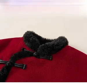 Detail of red wool fabric with black faux fur collar and traditional Chinese frog buttons