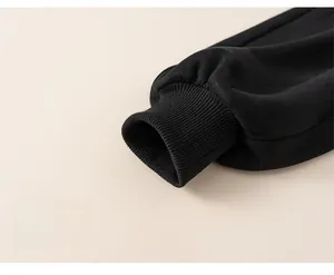 Detailed macro view of elastic ribbed cuffs on black children's winter thermal trousers