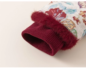 Detail of floral jacquard sleeves with red faux fur trim and ribbed knit cuffs