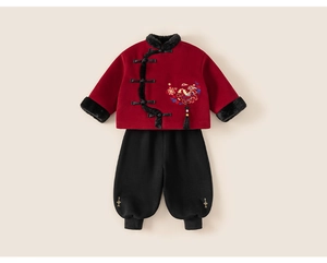 Detailed view of red traditional Chinese top with embroidery and black cuffed pants