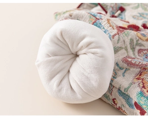 Detailed close-up of winter floral jacquard fabric with thick soft white fleece lining