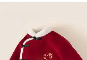 Close-up of red Chinese winter jacket with white faux fur collar and cartoon embroidery