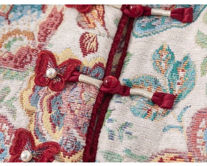 Detailed macro view of floral brocade fabric and handmade butterfly knots on kids' Hanfu
