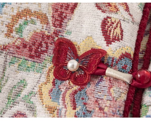 Close-up of traditional Chinese winter coat featuring 3D butterfly and jacquard fabric