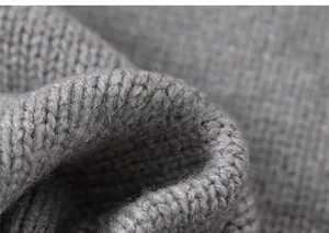 Close-up of grey knit fabric texture showing soft fiber quality and detailed stitch pattern