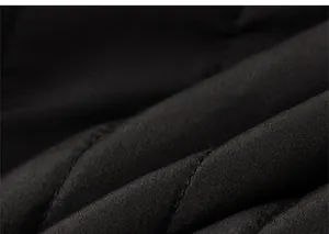 Close-up of black quilted fabric texture for children winter clothing with diamond stitching